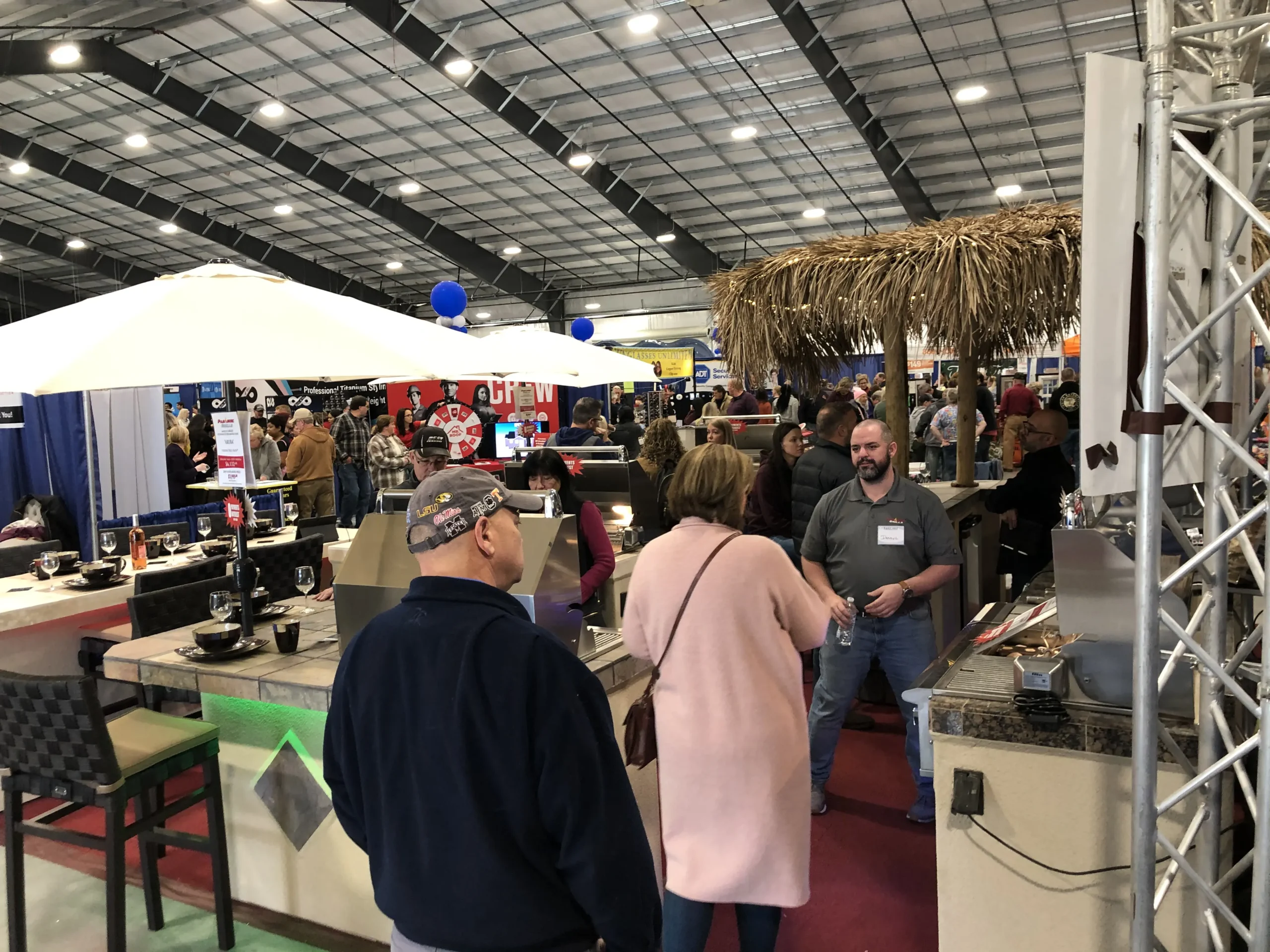 A busy home show floor filled with exhibits and visitors