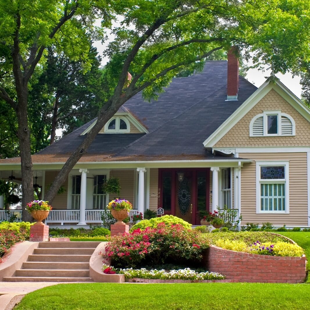 Extremely colorful classic restored house with beautiful landscaping in a rural city.